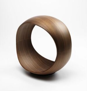  "Rodeo" by Frode Skretting, a laminated bentwood piece resembling a three-dimensional ring, with a smooth walnut finish highlighting natural wood grains, set against a white background.