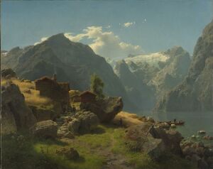  "Balestrand," an oil on linen landscape painting by Hans Gude, depicting a lush green and rocky foreground by a lake, with towering sunlit snow-capped mountains in the background under a light blue sky with sparse clouds.