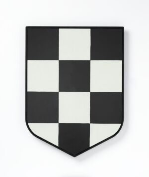  A matte, shield-shaped object with a checkered pattern of five rows and four columns, alternating between black and white squares, against a plain white background. Artist and title unknown.