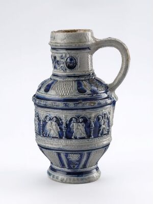  An ornate stein made from salt-glazed stoneware titled 'Bondedans' by an unknown artist, featuring a cobalt blue relief decoration of dancing figures around the body, with a flared rim and a stout handle.