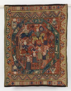  A handwoven tapestry titled "De hellige tre konger" by an unidentified woman artist, depicting the Biblical scene of the Three Wise Men in a central panel surrounded by decorative geometric and floral borders in a rich palette of reds, blues, greens, and golds on an earth-toned background.