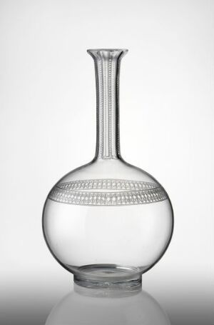  A clear, lead crystal decanter by Hadeland Glassverk with intricate cut designs, standing against a gradient background from white to gray. The bottom half is spherical with a decorative band, and the top half features an elongated neck with a fluted opening.