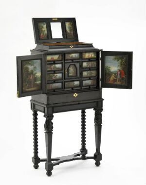  An antique dark wood cabinet with numerous compartments and drawers, adorned with miniature paintings, is standing on a table with elegantly turned legs. The cabinet seems to serve both as a functional piece of furniture and as a display for art.