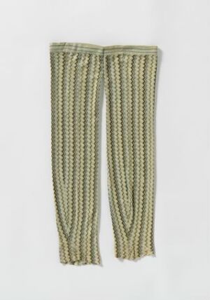  A pair of muted green, ribbed, knitted or crocheted stockings or leg warmers positioned vertically against a white background, featuring subtle striped patterns in varying shades of green.