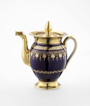  An ornate teapot with deep blue coloring and detailed gold patterns, featuring a gold spout and handle, set against a white background.