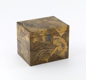  A small cube-shaped box with a polished surface featuring intricate brown and ochre designs of organic and geometric patterns, suggestive of an antique or classical eastern art style, displayed against a plain background.