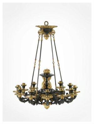  An antique gold and black chandelier with eight curved arms and candleholders hangs against a light grey background.