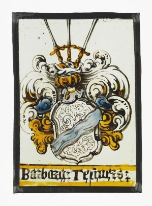  An antique stained-glass panel featuring a shield with gray-blue swirling patterns, surrounded by gold baroque flourishes and two indigo insets, with a golden-yellow text banner reading "Barbaeu Tėquiurs" below.