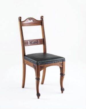  A G. N. Huseby designed "Spisestuestol" dining chair with profiled, relief-carved and lacquered mahogany veneer and a black leather seat against a neutral white background. The chair features turned front legs, a high back with intricate carving, and an ornamental top crest.