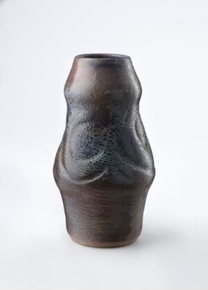  A ceramic vase with a design resembling the human figure, featuring a dark brown base color with a blue-gray mottled pattern on the upper half, set against a clean, white background.