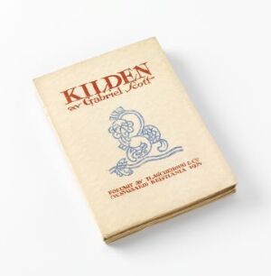  Vintage book titled "Kilden - av Gabriel Scott" with artistic contributions by Albert Jærn, featuring red and blue text with an ornate blue graphic on a textured beige cover, placed on a light-grey background.