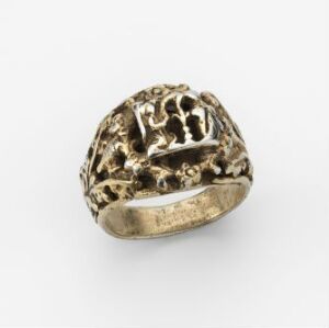  A gilded silver ring with intricate, organic patterns, designed by an unidentified artist and showcased against a neutral background.