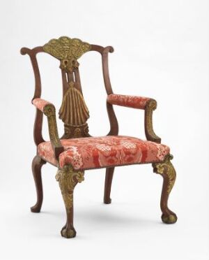 
 An elegant red-painted beechwood armchair titled "Armstol" by an unidentified artist, adorned with gold gilded carvings and an upholstered velvet seat with floral patterns.