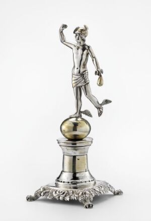  A silver-colored statuette of an athletic male figure with a laurel wreath on his head, raising his right hand triumphantly and standing on a detailed base with acanthus leaf patterns, suggesting an artifact of victory or celebration.