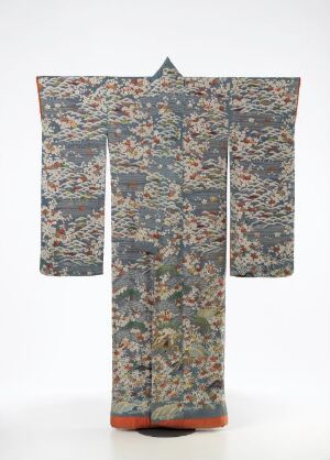 
 A traditional Asian kimono with an intricate, multicolored floral and figurative pattern on a light background, featuring wide sleeves and an orange-red hem.