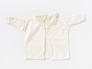  An off-white baby sweater with long sleeves and decorative patterning, laid flat on a light gray background.