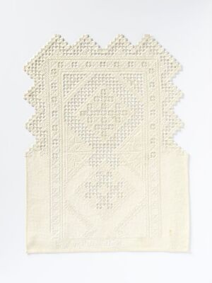  Antique off-white handkerchief or decorative lace panel with a battlement-inspired upper border and a central diamond-shaped lattice pattern on a plain, light background.