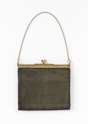  A small, structured handbag with a fine dark mesh pattern interspersed with light specks, featuring a golden frame and clasp, and a slender matching shoulder strap against a plain light background.