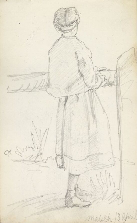 Kvinne stående ved port