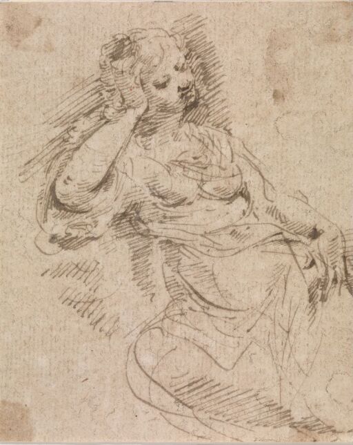 Woman seated with her head in her hand