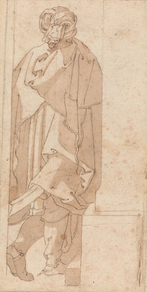 A man wearing a turban and a cloak, seen from behind