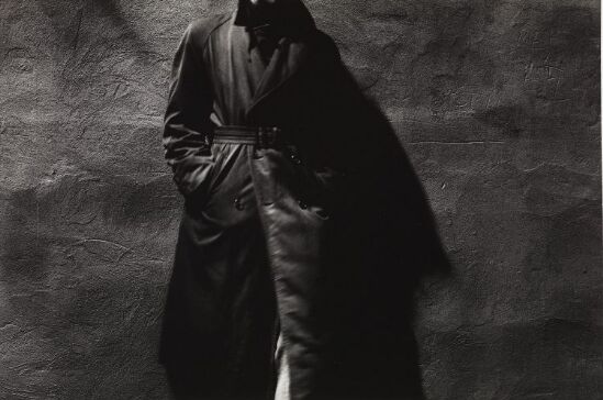 Man standing against a wall