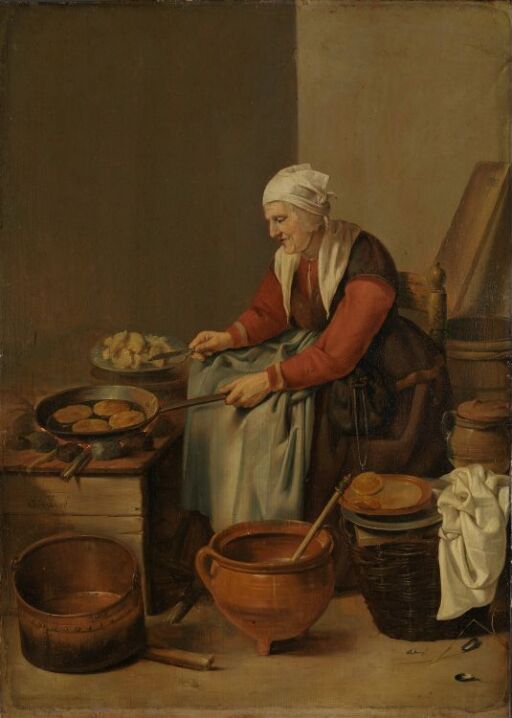 En gammel kone i sitt kjøkken