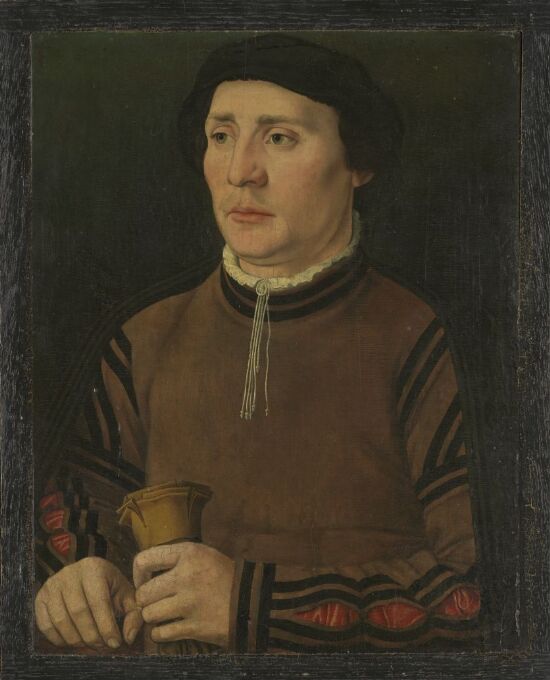Portrait of a man holding gloves